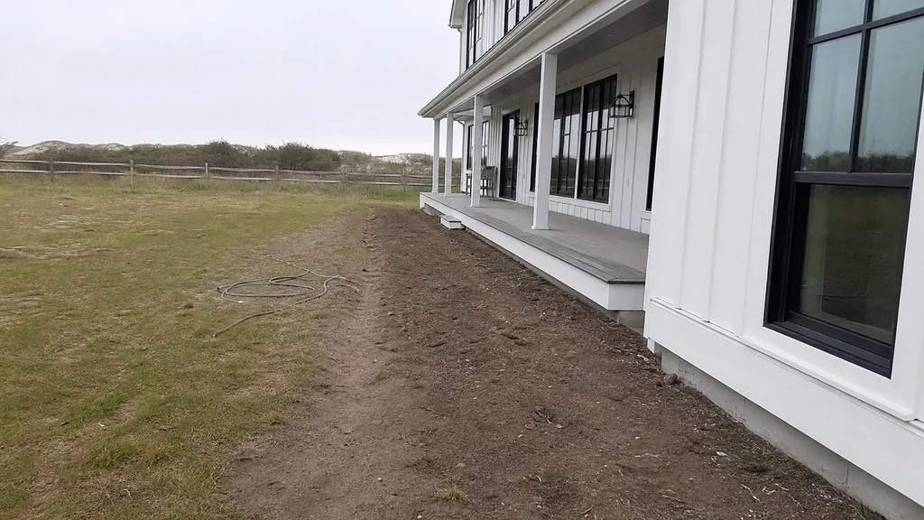 Board-and-batten beach house, dune border — the original photo