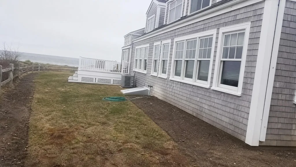 Shingled beach house, coastal path — the original photo