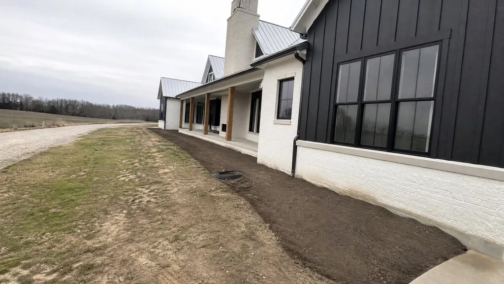 Whitewashed brick farmhouse, foundation border — the original photo
